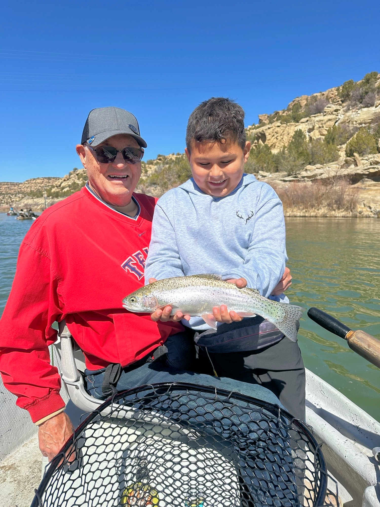 Client releasing large rainbow trout.